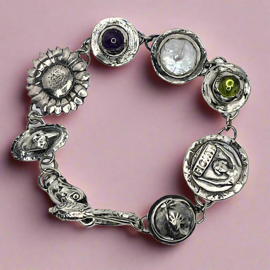 Dissent Charm Bracelet in reclaimed sterling silver with amethyst, pearl, peridot. found at www.phoenixsilverllc.com