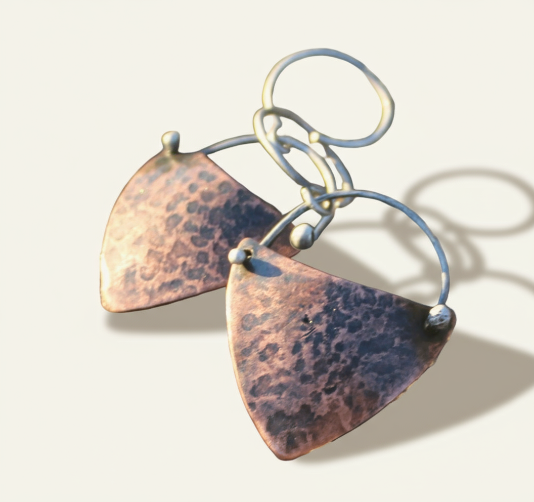 Copper kite shield earrings with hammered texture, silver forged-in-place details, and silver earwires.