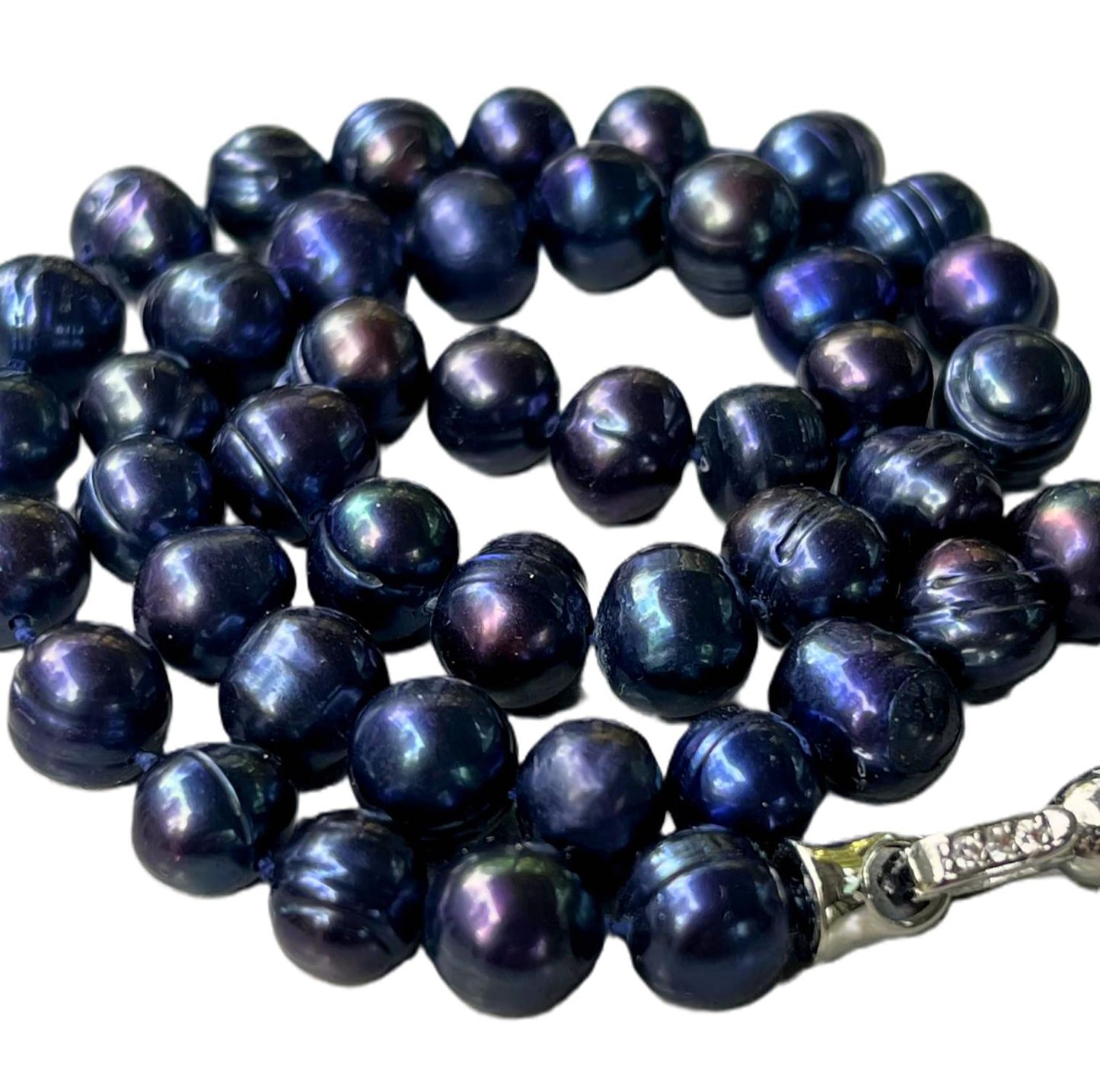 String of dark blue 8mm peacock pearls with 18k white gold plated clasp on a white background