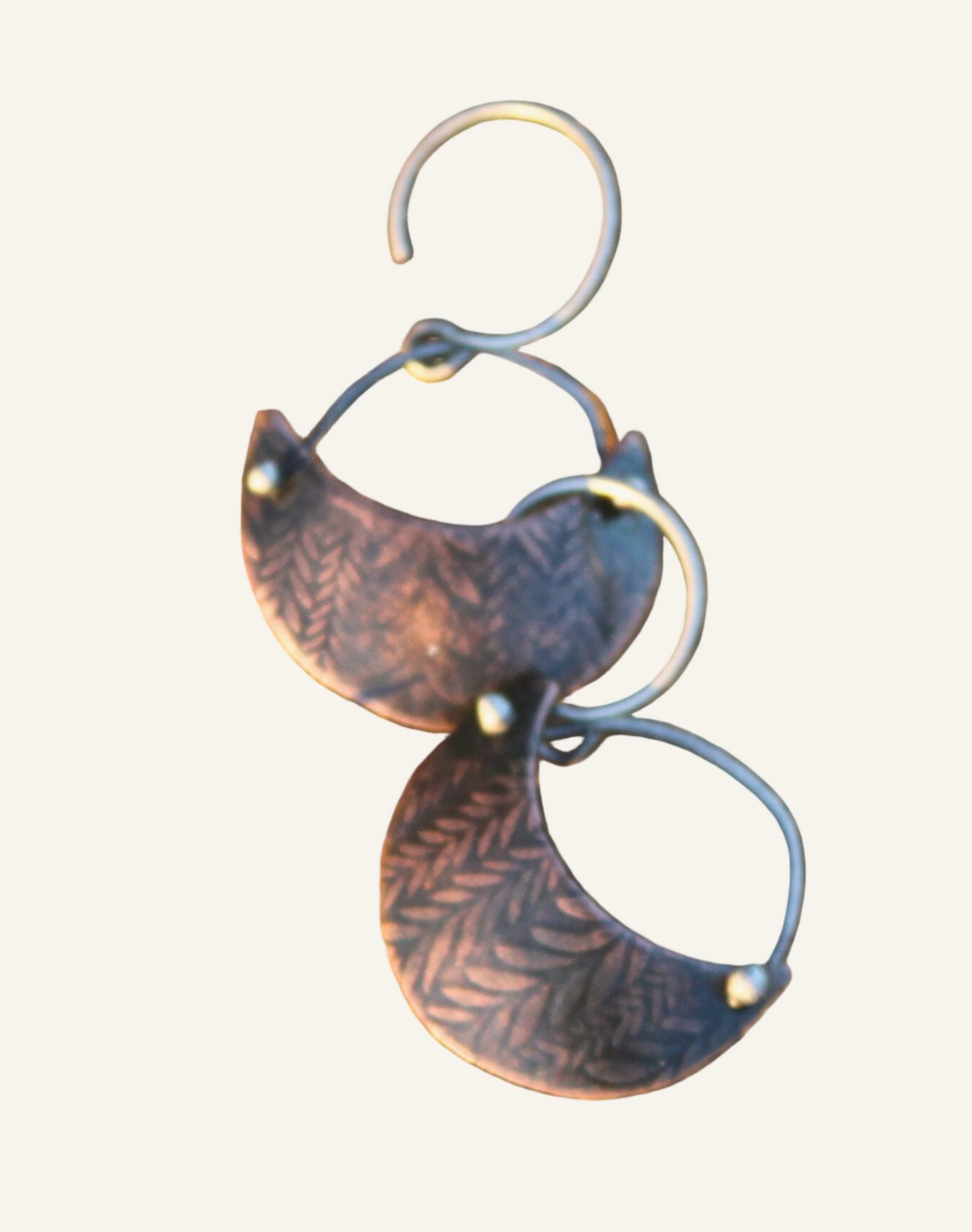 Copper moon shaped shield earrings with vinework texture, silver forged in place details, and silver ear wires from Phoenix Silver LLC.